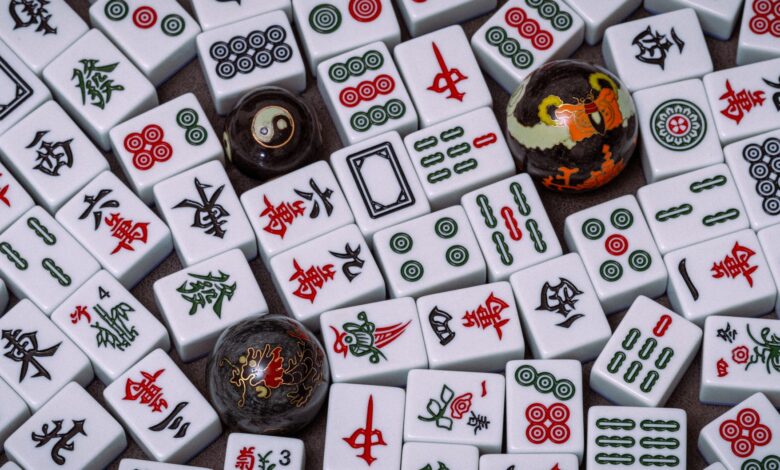 Close-up of traditional Mahjong tiles with Baoding balls, showcasing intricate Chinese symbols and patterns.