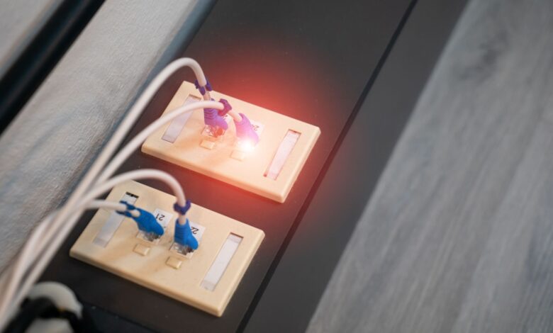 Close-up view of Ethernet ports with cables and illuminated LED indicator. Modern data connection setup.