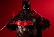 Dramatic Batman inspired cosplay featuring black and red armor against a vibrant red background.