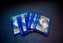 High angle of set of trading cards with images of fictional creatures placed against gray background