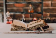 Close-up of a wooden wand and ancient spell book in a mystical, rustic environment.