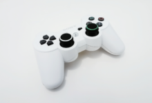 Close-up of a white gaming controller, ideal for PlayStation console enthusiasts.