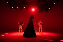 Star Wars characters in dramatic red lighting on a stage. Perfect for entertainment-themed imagery.