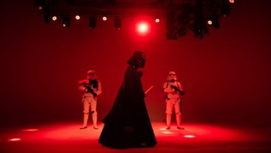 Star Wars characters in dramatic red lighting on a stage. Perfect for entertainment-themed imagery.