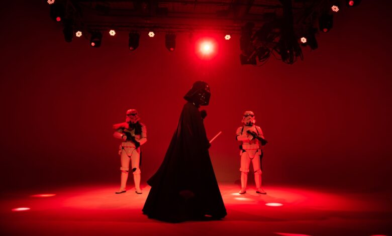 Star Wars characters in dramatic red lighting on a stage. Perfect for entertainment-themed imagery.