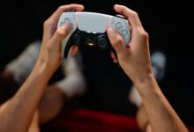 Hands gripping a modern game controller, ready for immersive gaming experience.