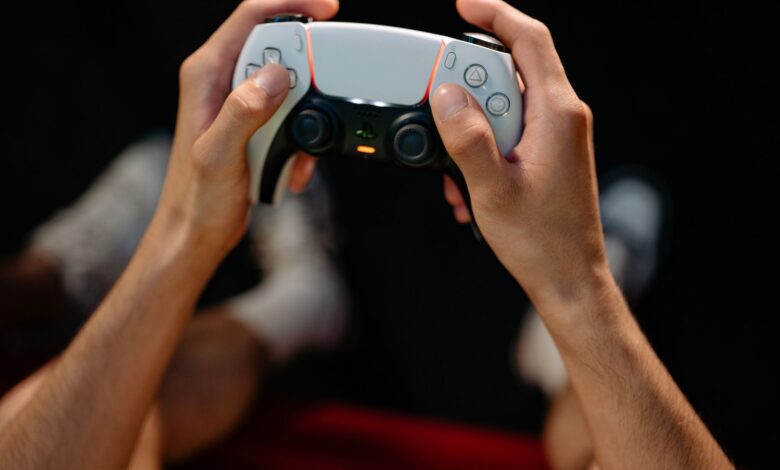 Hands gripping a modern game controller, ready for immersive gaming experience.