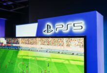 PS5 gaming station featuring a live soccer match onscreen, showcasing high-quality graphics.