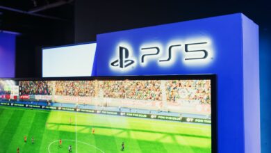 PS5 gaming station featuring a live soccer match onscreen, showcasing high-quality graphics.