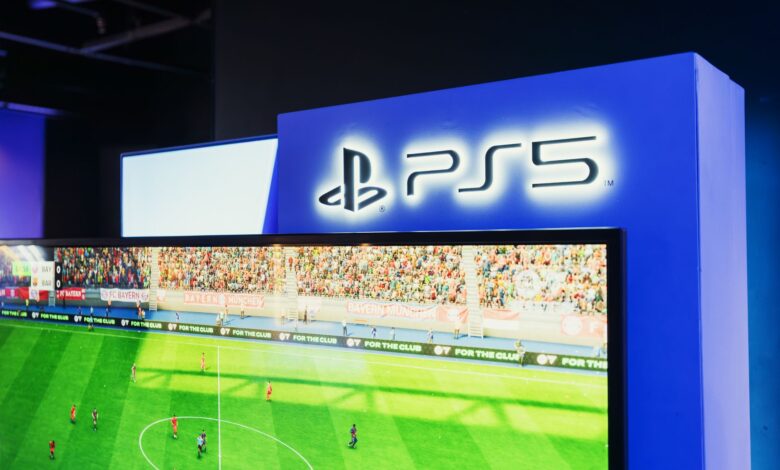 PS5 gaming station featuring a live soccer match onscreen, showcasing high-quality graphics.