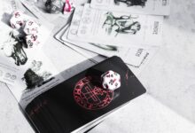 A collection of tarot cards and gaming dice on a tabletop, featuring mystical illustrations.