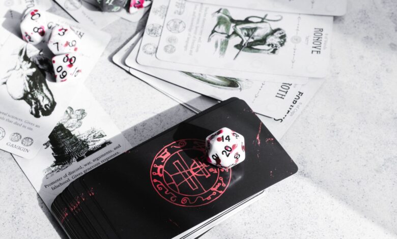 A collection of tarot cards and gaming dice on a tabletop, featuring mystical illustrations.