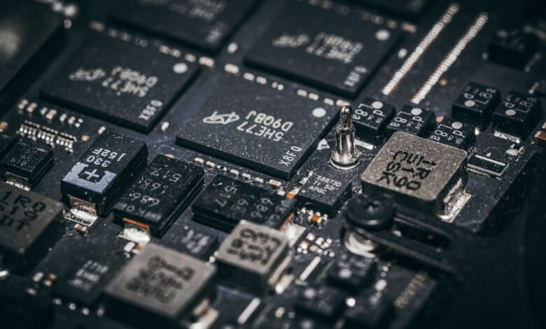 Detailed close-up of electronic microchips on a circuit board, showcasing technology and engineering intricacies.