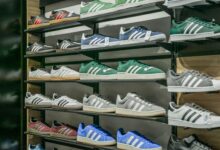Colorful sneakers arranged on store shelves showcasing trendy footwear options.