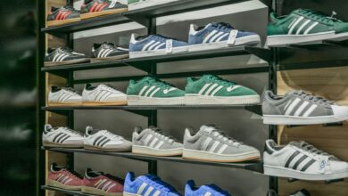 Colorful sneakers arranged on store shelves showcasing trendy footwear options.