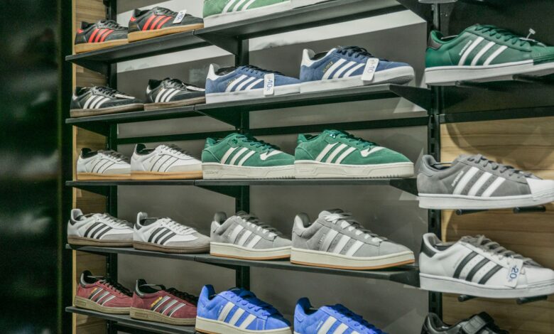Colorful sneakers arranged on store shelves showcasing trendy footwear options.