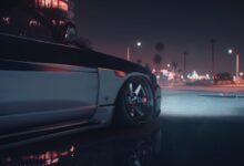 A stylish sports car captured at night in an urban environment with city lights.