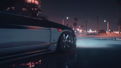 A stylish sports car captured at night in an urban environment with city lights.