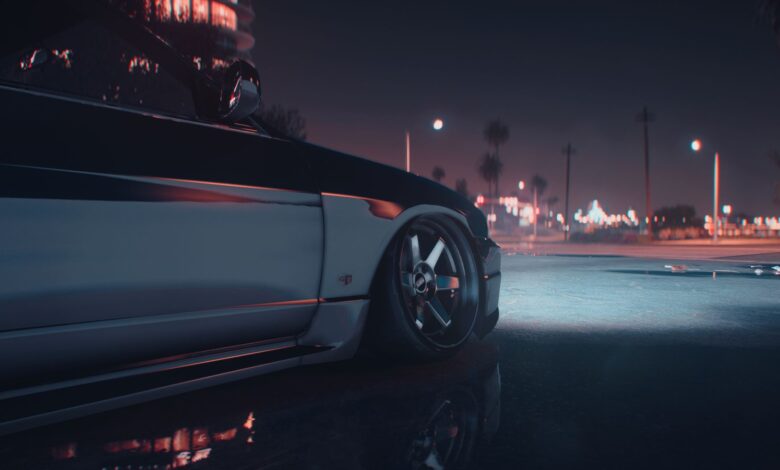 A stylish sports car captured at night in an urban environment with city lights.