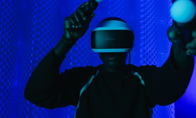 Person enjoying a virtual reality gaming session with a VR headset and controllers.