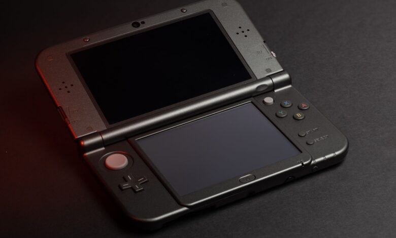 Detailed photo of a Nintendo 3DS console with dual screens and buttons, perfect for gaming enthusiasts.