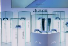 PlayStation 5 consoles and accessories on display in a sleek, futuristic showroom.