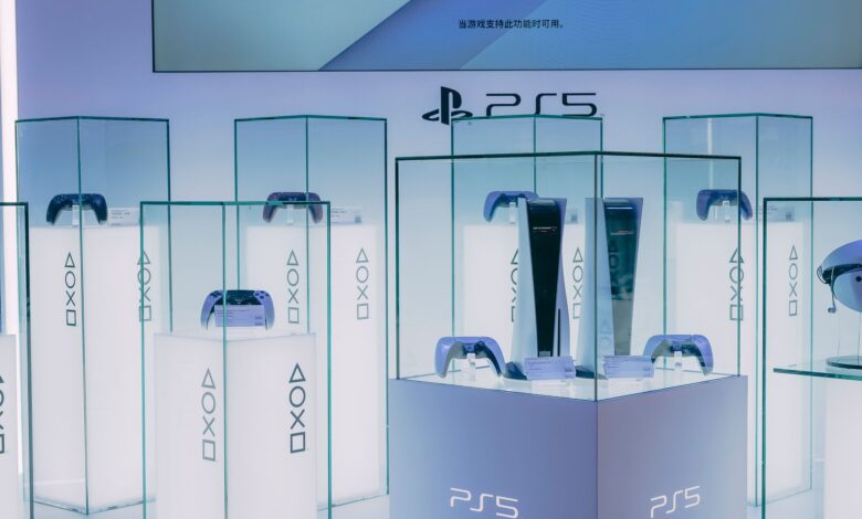 PlayStation 5 consoles and accessories on display in a sleek, futuristic showroom.