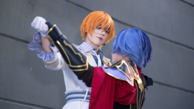 Dynamic cosplay scene with characters in vibrant outfits showcasing dramatic interaction.
