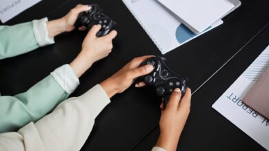Two people playing video games with controllers, highlighting teamwork and gaming experience.