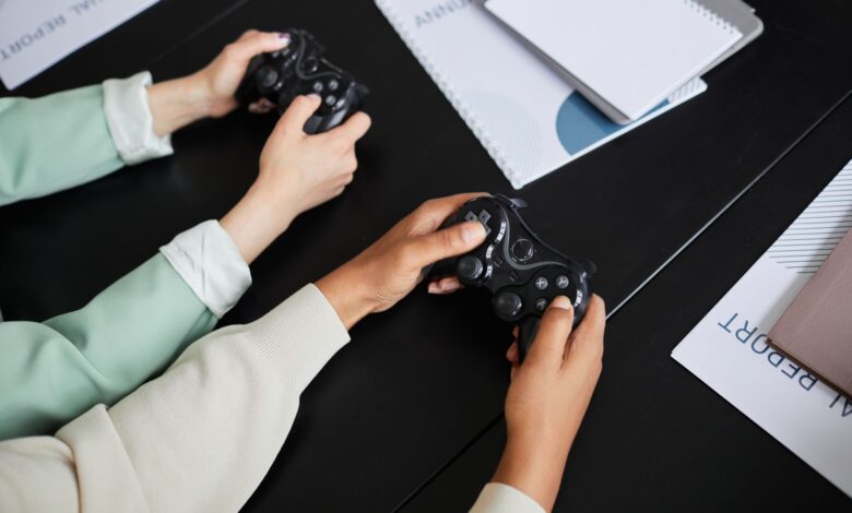 Two people playing video games with controllers, highlighting teamwork and gaming experience.
