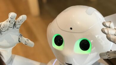 A futuristic humanoid robot with glowing green eyes in a modern setting.