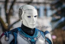 Close-up of a futuristic humanoid robot with metallic armor and blue LED eyes.