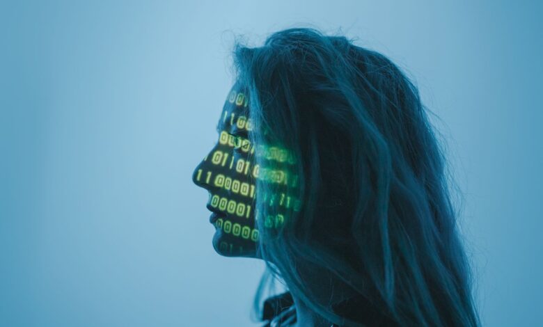 Silhouette of a woman with binary code projected on her face in a digital concept setting.