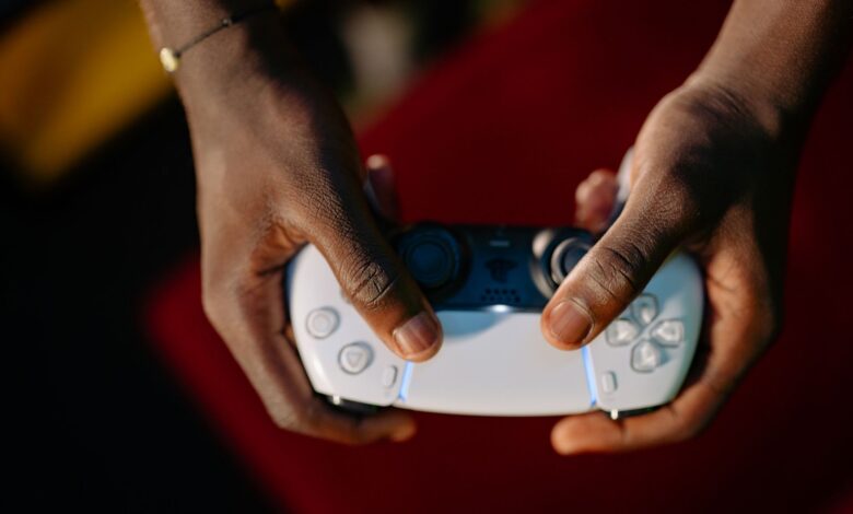 Close-up view of hands gripping a wireless gaming controller.