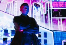 A striking portrait of a man in cyberpunk fashion, illuminated by vibrant neon lights.