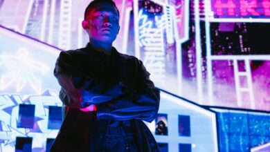 A striking portrait of a man in cyberpunk fashion, illuminated by vibrant neon lights.