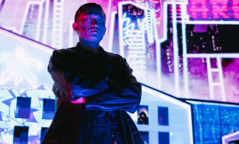 A striking portrait of a man in cyberpunk fashion, illuminated by vibrant neon lights.