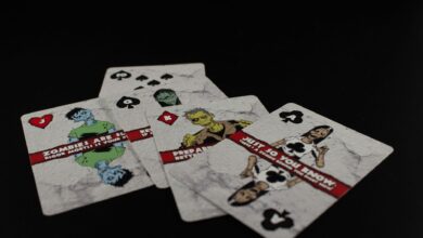 A dramatic still life of zombie-themed playing cards on a black background creates a spooky ambiance.
