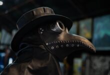 Close-up of a historically styled plague doctor mask with a beak-shaped nose.