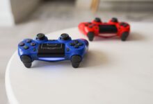 Close-up of PlayStation controllers on a white table for gaming enthusiasts.
