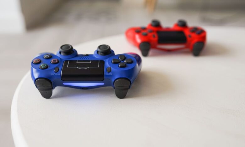 Close-up of PlayStation controllers on a white table for gaming enthusiasts.