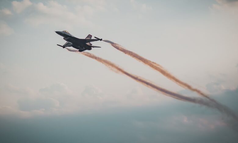 Dynamic capture of a military fighter jet soaring through a cloudy sky.