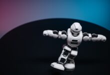 A futuristic white robot toy performing on a sleek dark surface.