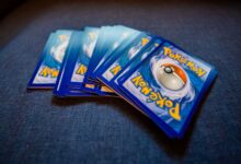 From above of pack of collectible cards with images of fantastic creatures on backs located on gray backdrop
