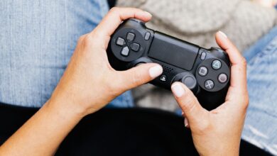 Person holding a video game controller, ideal for leisure and gaming themes.