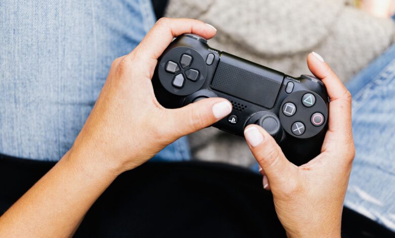 Person holding a video game controller, ideal for leisure and gaming themes.