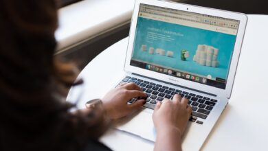 Businesswoman working on laptop with Android 6.0 Marshmallow webpage open.