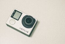 Top view of a GoPro Hero 4 action camera with a white background, emphasizing its design.