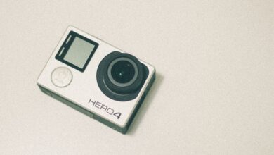 Top view of a GoPro Hero 4 action camera with a white background, emphasizing its design.