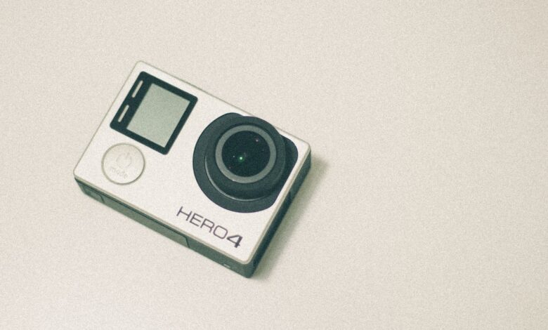 Top view of a GoPro Hero 4 action camera with a white background, emphasizing its design.